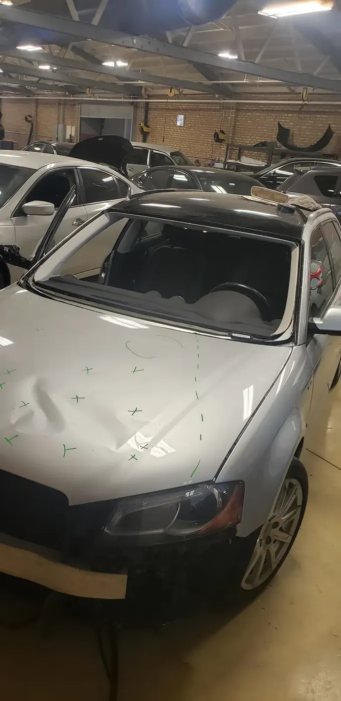 Windshield replacement on a silver sedan