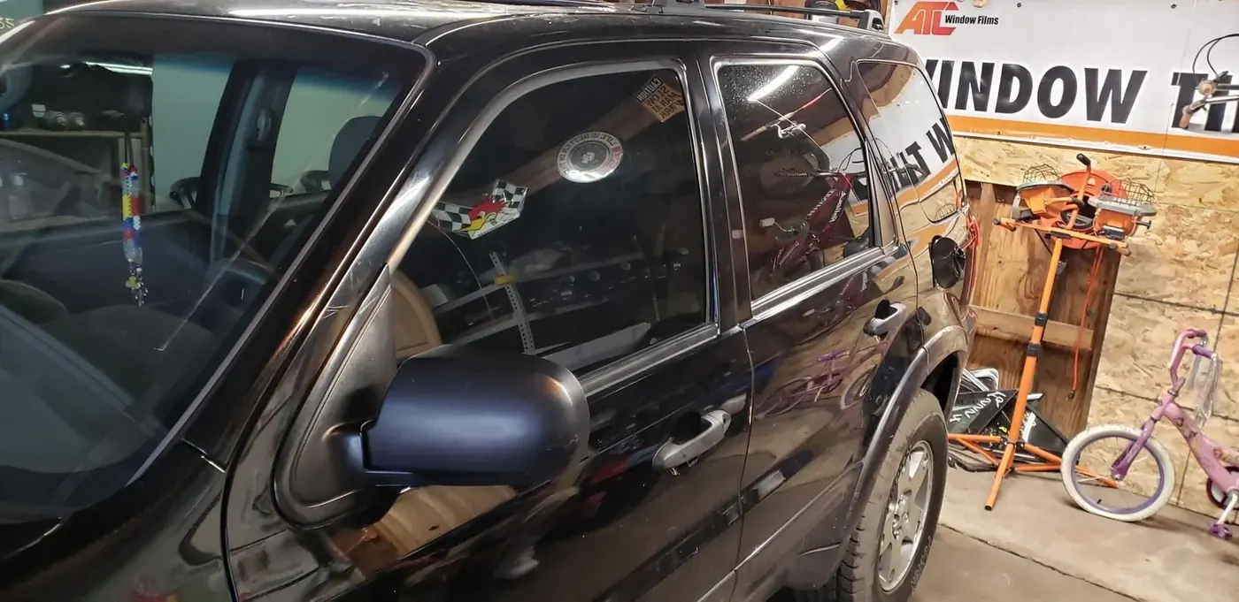 Mobile auto glass and tint service on an SUV at the customer's location
