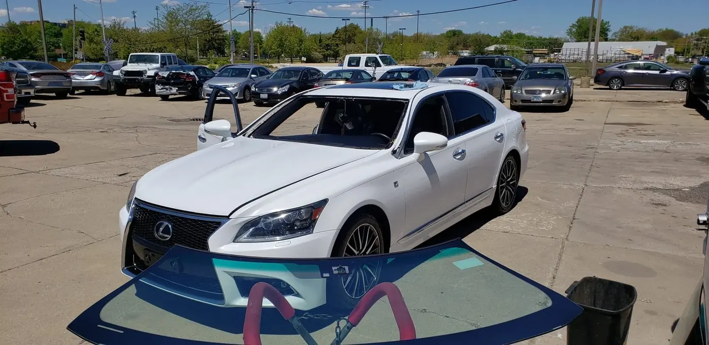 New windshield ready to be installed on a white Lexus by Mr. Glass Chicago technicians