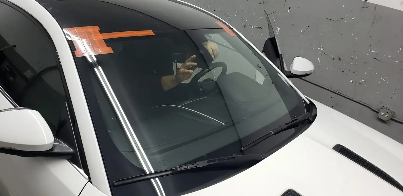 Close view of windshield replacement preparation after crack damage